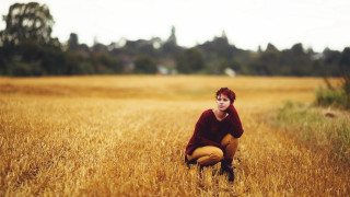 Woman kneeling wheat field red - free autumn wallpaper