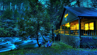Cabin river night lit window - a cabin free wallpaper