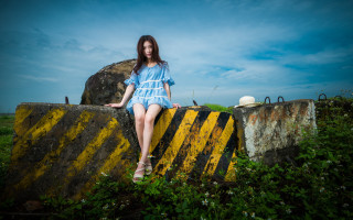 Woman sitting rock field blue - a rock in a field of grass free wallpaper