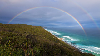 Rainbow beach cliff ocean cloudy - carl critchlow free wallpaper