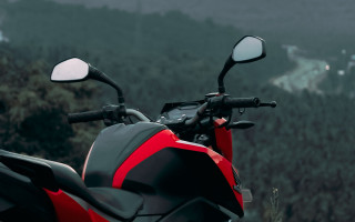 Red motorcycle hillside forest building - a lush green hillside next free wallpaper