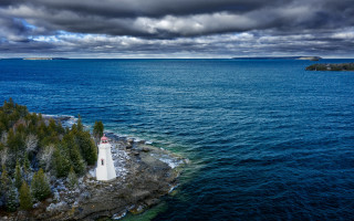 Lighthouse island ocean cloudy sky - free ship wallpaper