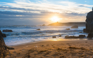Beach rock formation sunset waves - the shore and a person free wallpaper