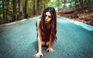 Woman red bodysuit woods laying - the road free wallpaper