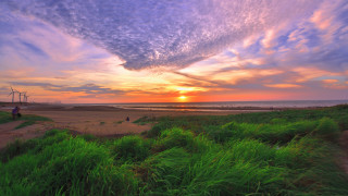 Sunset beach windmill person clouds - a sunset over a beach free wallpaper