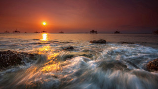 Sunset water ships rocks shoreline - free ship wallpaper