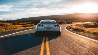 White sports car country road 2 - a white sports car free wallpaper