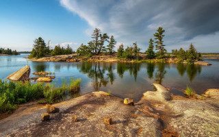 Lake forest rocks cloudy sky - under a cloudy sky free wallpaper