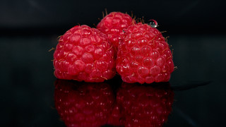Three raspberries black surface reflection - a reflection of them free wallpaper