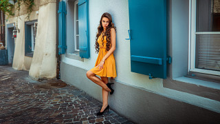 Woman yellow dress blue shutters - a woman leaning against a wall free wallpaper