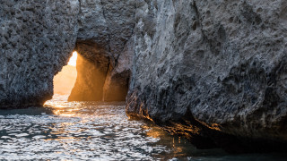 Cave entrance water sunset forest - free light wallpaper