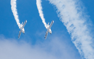 Two airplanes smoke trail precisionism - smoke behind them free wallpaper