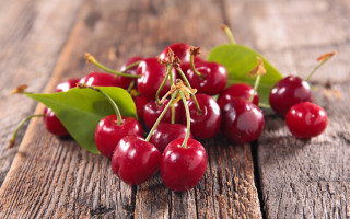 Cherries wooden table leaves blurry - a bunch of cherries free wallpaper