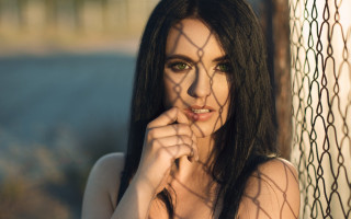 Woman greeneyes fence pose longhair - behind a fence free wallpaper