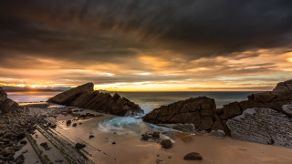 Beach rocks water cloudy sunset 2 - a few wave free wallpaper