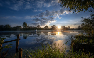 Lake boat sunset clouds trees 3 - the water and a sunset in the background free wallpaper