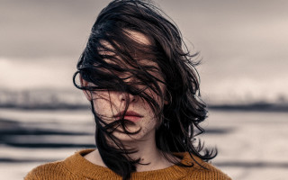 Woman blowing hair brown sweater - a brown sweater free wallpaper