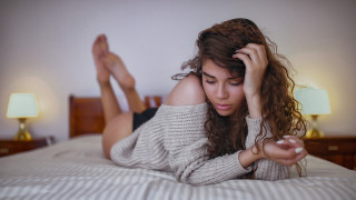 Woman laying bed curly brown - the side of the bed free wallpaper