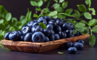 Wooden bowl blueberries green leaves 2 - a wooden spoon free wallpaper
