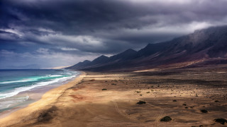 Beach mountain cloudy sky ocean - stormy weather free wallpaper