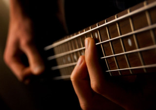 Person playing guitar fingers strings - grunge free wallpaper