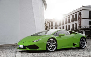 Green sports car cobblestone street 2 - a green sports car free wallpaper