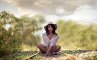 Woman hat train track woods - a train track in the background free wallpaper