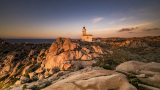 Lighthouse rocky cliff sunset ocean 4 - a lighthouse free wallpaper