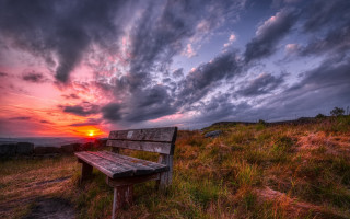 Bench hillside grass sunset cloudy - hillside under a cloudy sky free wallpaper