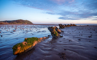 Bascove beach rocks water hill - a hill in the distance free wallpaper for desktop