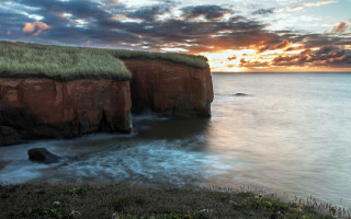 Grassy roof cliff ocean sunset - dramatic light free wallpaper