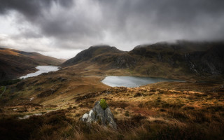 Mountain lake cloudy sky rock - a grassy field below free wallpaper