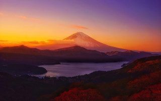 Mountain lake sunset snow capped - peak in the distance free wallpaper
