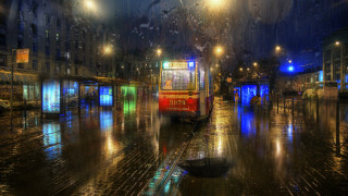 Red bus rainy night cityscape - side and a person free wallpaper