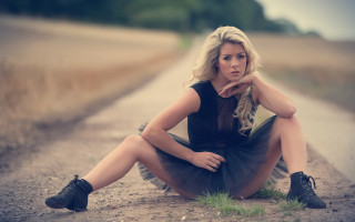 Woman sitting on tire outdoors 2 - a tire free wallpaper
