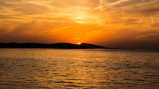 Sunset water island clouds dusk - a small island in the distance free wallpaper
