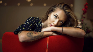 Tattooed woman red chair portrait - a red chair free wallpaper