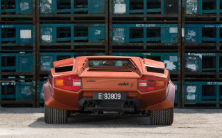 Red sports car parked crates - side profile free wallpaper