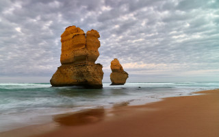 Large rock formation beach ocean 2 - the ocean under a cloudy sky free wallpaper