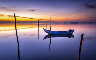 Sunset boat reflection clouds ocean - free ship wallpaper