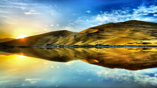 Mountain lake sun clouds reflection - a bright sun in the background free wallpaper