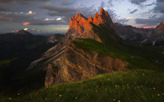 Mountain range grassy field sunset - a grassy field below free wallpaper