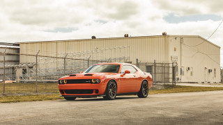 Red sports car building fence - a chain link fence free wallpaper