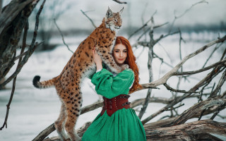 Woman green dress cat snow - a branch in the snow free wallpaper