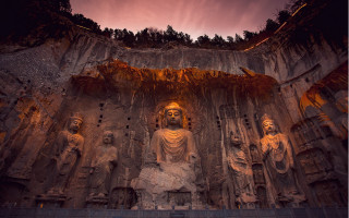 Buddha statues cave sunset flame - a cave free wallpaper