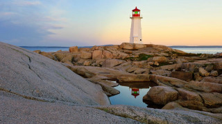 Lighthouse rocky shore sunset ocean 2 - the foreground and a sunset in the background free wallpaper