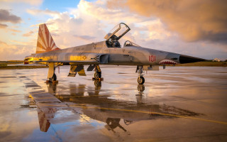 Fighter jet sunset clouds reflection - top of an airport tarmac free wallpaper