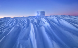 Large iceberg snowy hill blue - top of a snow free wallpaper