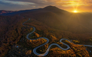 Winding road forest sunset mountain - the sun setting behind free wallpaper