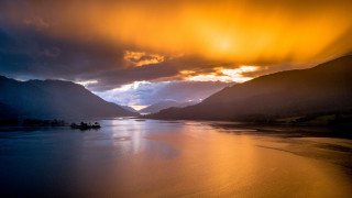 Lake boat mountain sunset cityscape - rich moody colours free wallpaper